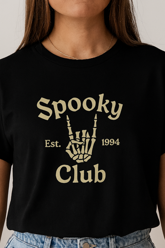 Unisex Spooky Club Tee showcasing a skeleton hand gesture with text design, perfect for Halloween enthusiasts, made from soft 100% cotton.