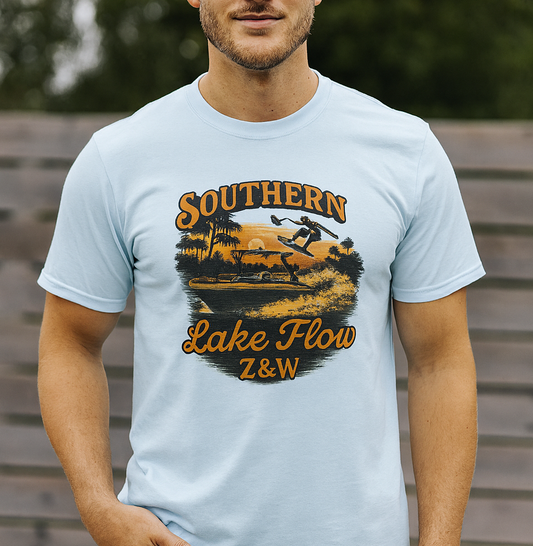 Model wearing the Southern Lake Flow T-Shirt in light blue, featuring a vintage-style graphic design that showcases lake activities, crafted from eco-friendly 100% US cotton for comfort and style.