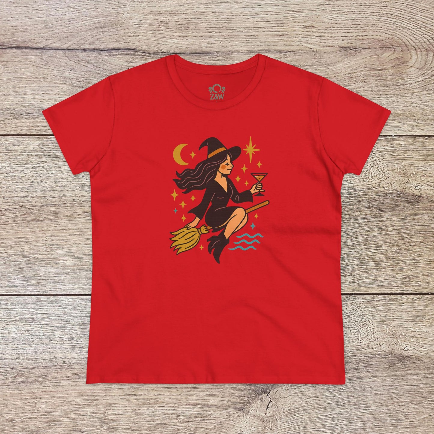 Witchy Night Out Tee available in bold red, featuring a charming witch flying on a broomstick with a drink, designed for stylish, comfortable wear.