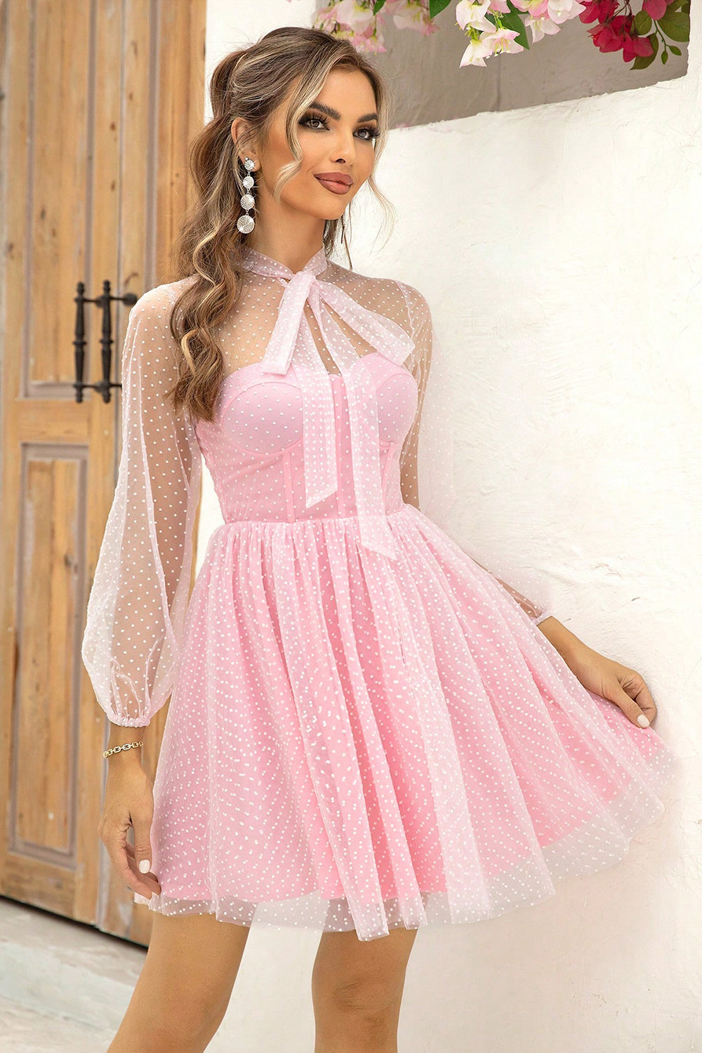 Model wearing the Chic Tie Neck Open Back Semi-Shear Mesh Dress with Lining in pink, featuring a tied front and sheer sleeves, ideal for a fashionable look.