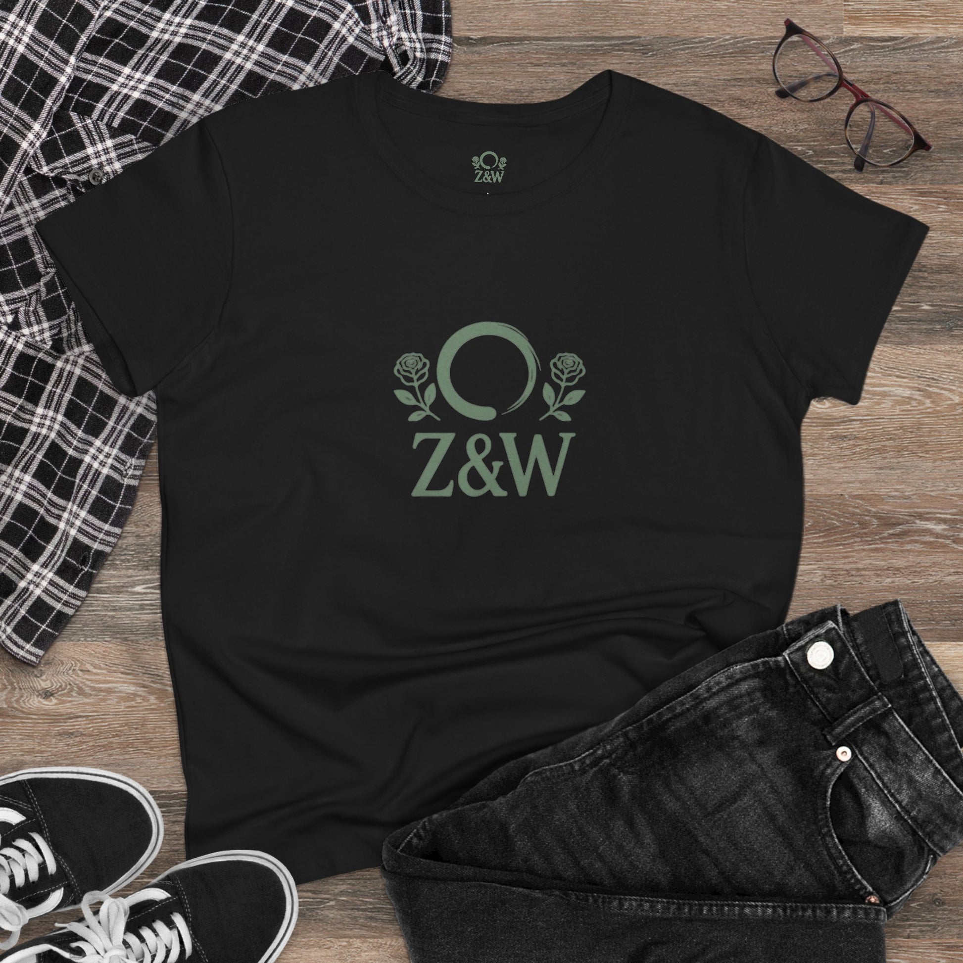 ZenAndWhiskey Classic 100% Cotton Tee showcased on a rustic wooden surface with black jeans and accessories, highlighting its comfort and everyday wear appeal.