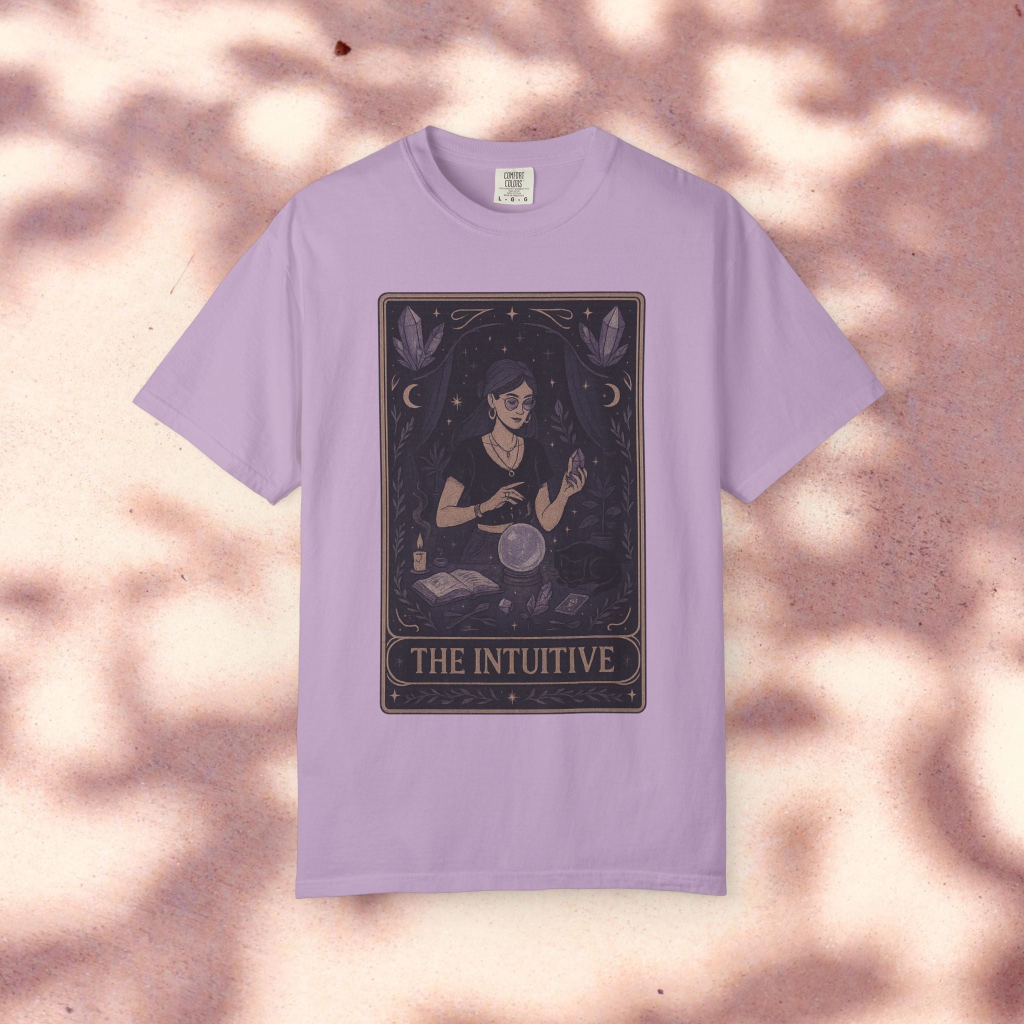 Intuitive Tarot Tee on a soft pastel background, highlighting the unique garment-dyed design and tarot imagery, suitable for casual and mystical fashion enthusiasts.