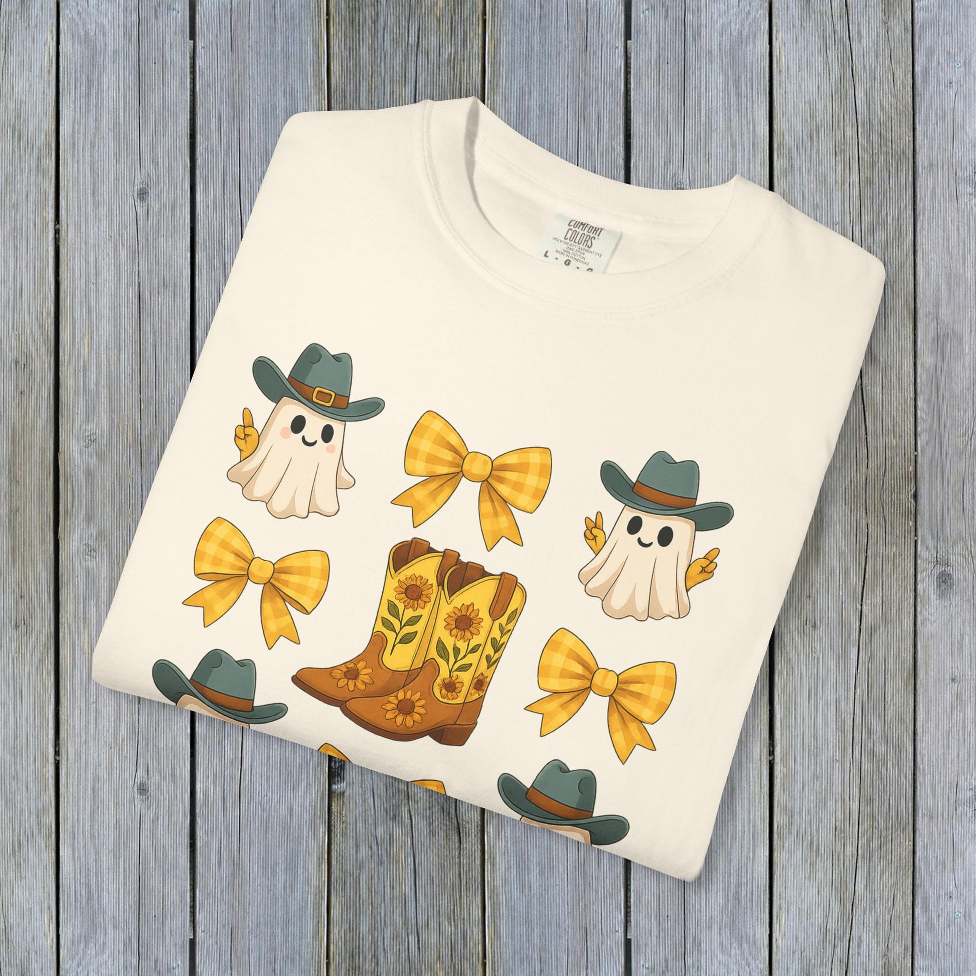 Cute Halloween T-Shirt featuring playful ghosts and cowboy boots design, perfect for unisex fall fashion, made with eco-friendly fabric.