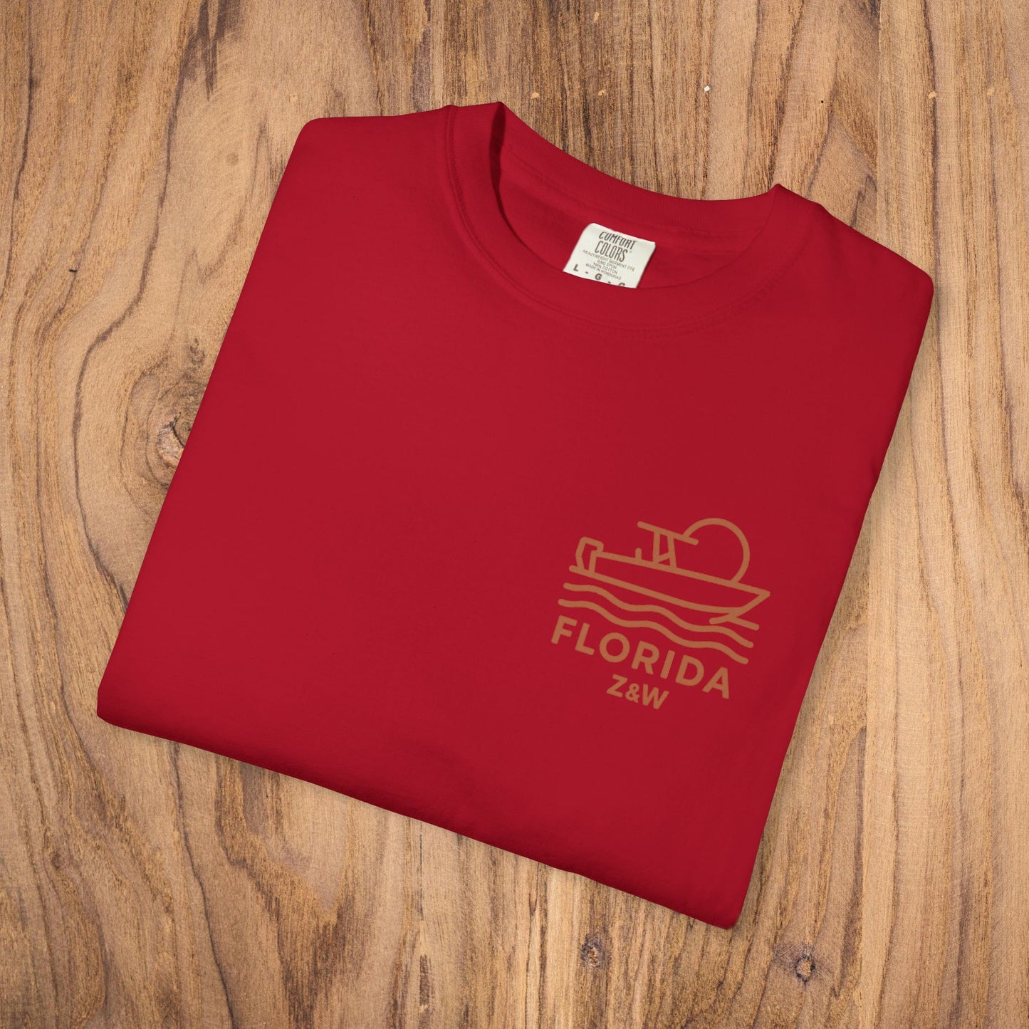 Unisex Florida Graphic Tee laid flat in vibrant red, showcasing a classic boat graphic, ideal for casual outfits.