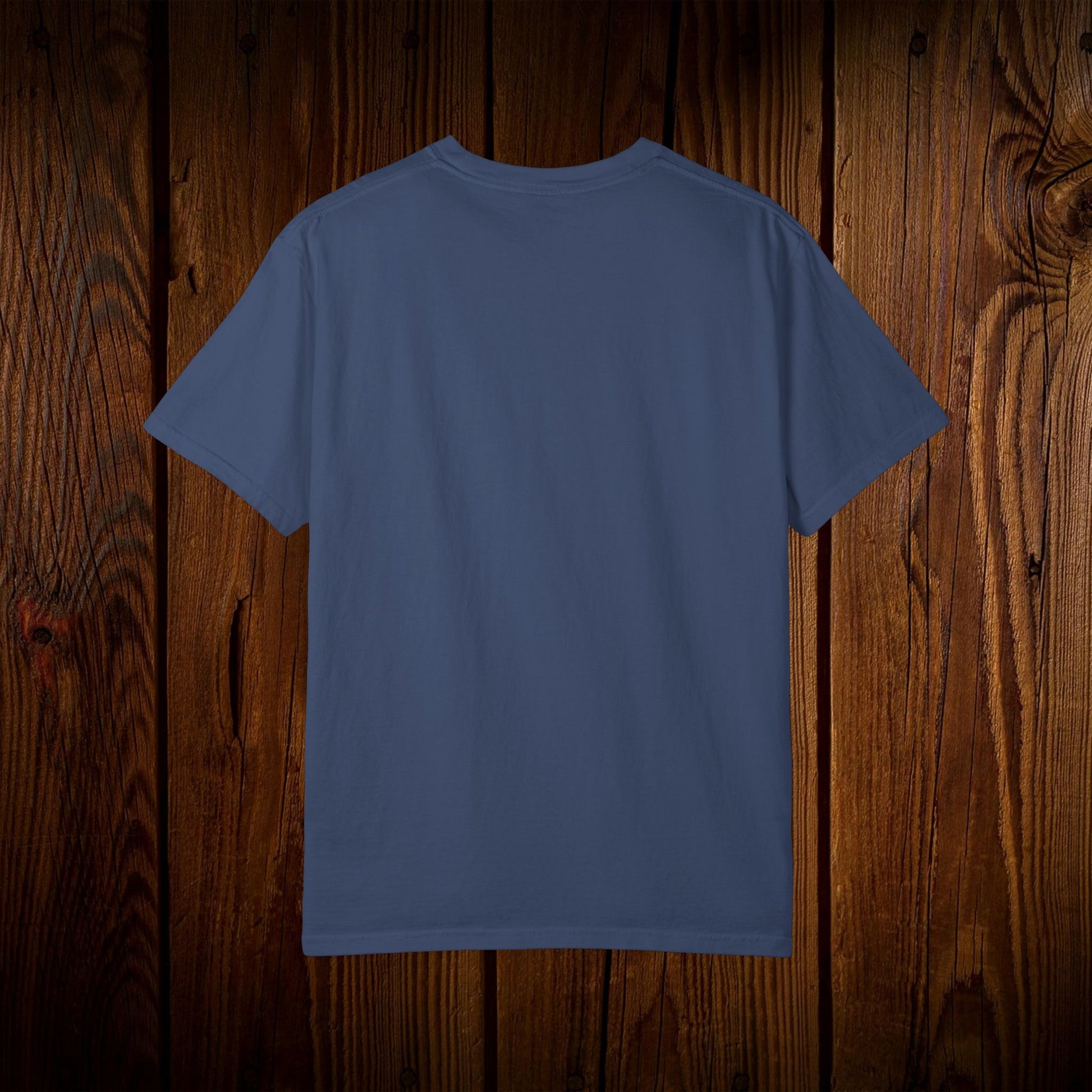 Back view of the Unisex Swamp-Bred Fairway-Fed Tee showcasing its comfortable design on wooden background.