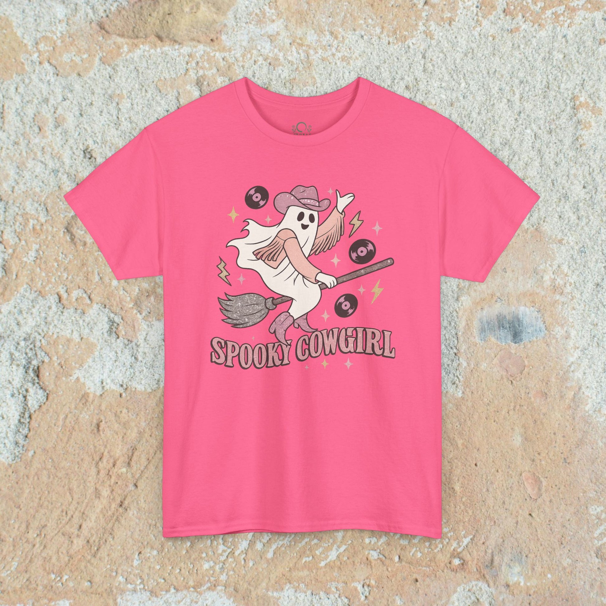 Stylish pink Spooky Cowgirl graphic tee design that captures a cheerful ghost with a broomstick and vinyl records, a must-have for Halloween lovers. Offered in sizes S to 5XL.