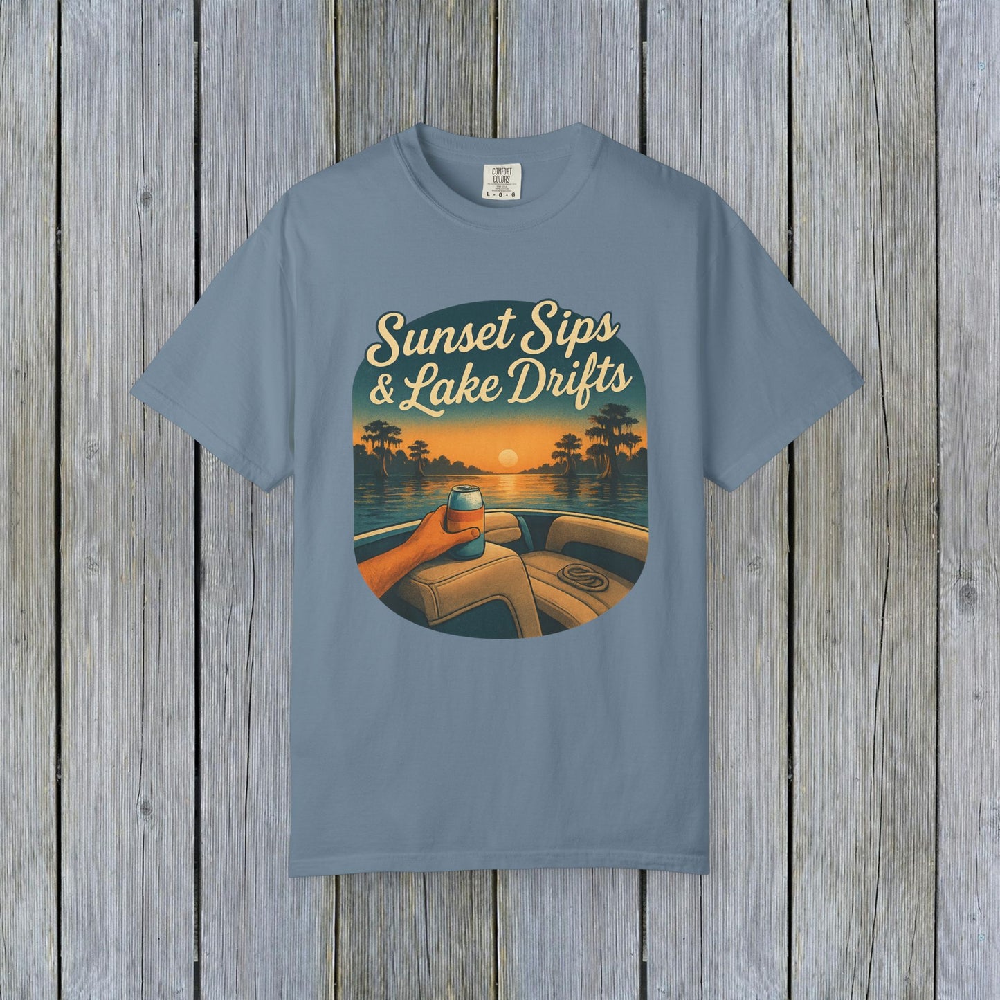 Lake Drifts T-Shirt in soft blue featuring a sunset graphic, perfect for casual wear.