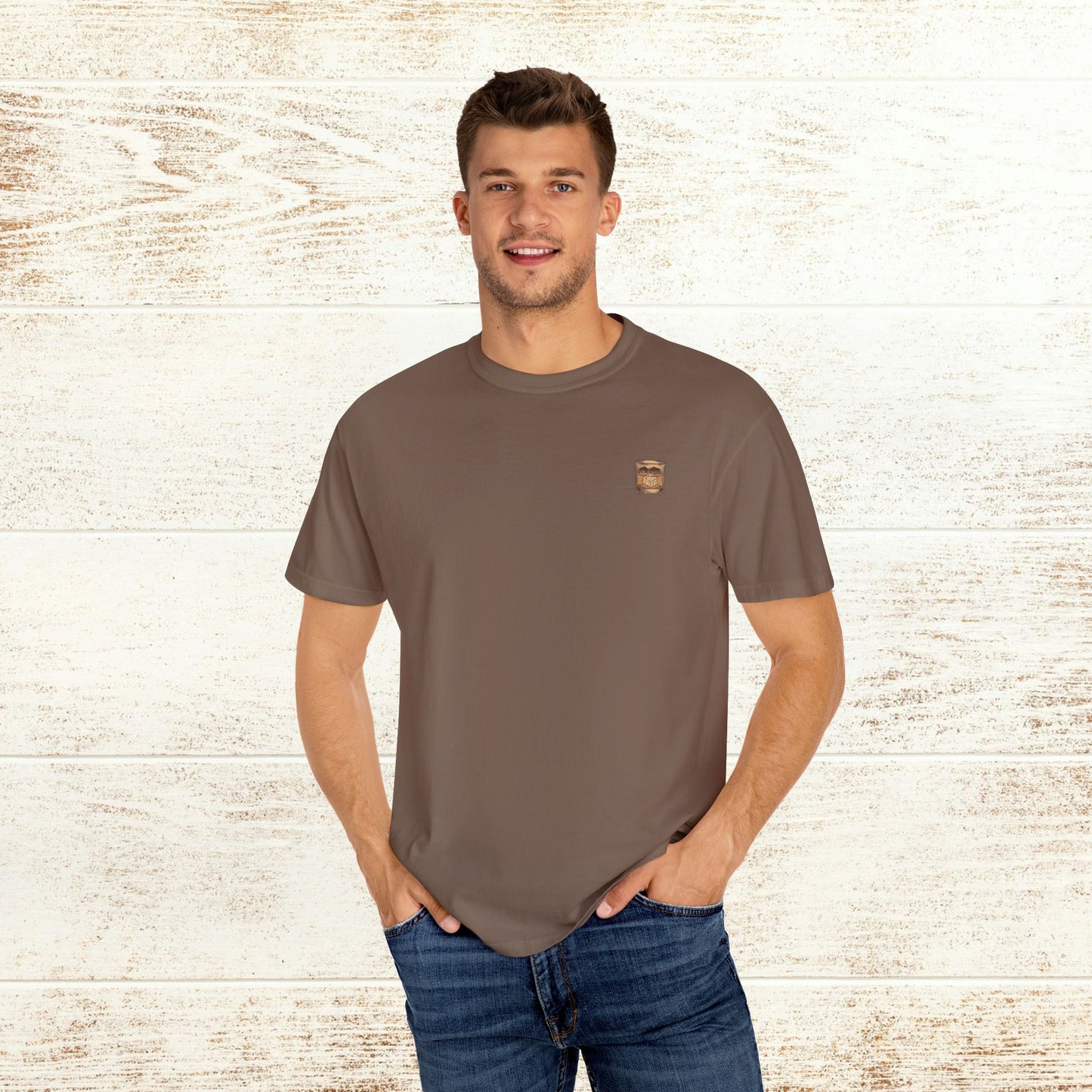 Men's Rodeo On The Rocks Tee, soft 100% US cotton, featuring unique garment-dyed style, model wearing light brown shirt.