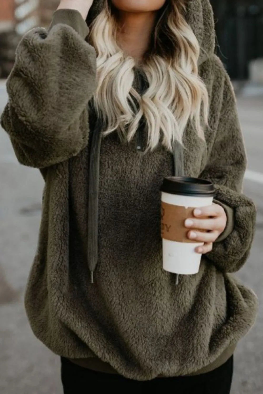 Cozy Full Size Teddy Hoodie with Quarter-Zip and Drawstring in olive green, modeled casually with a coffee cup, showcasing its trendy and cozy style.