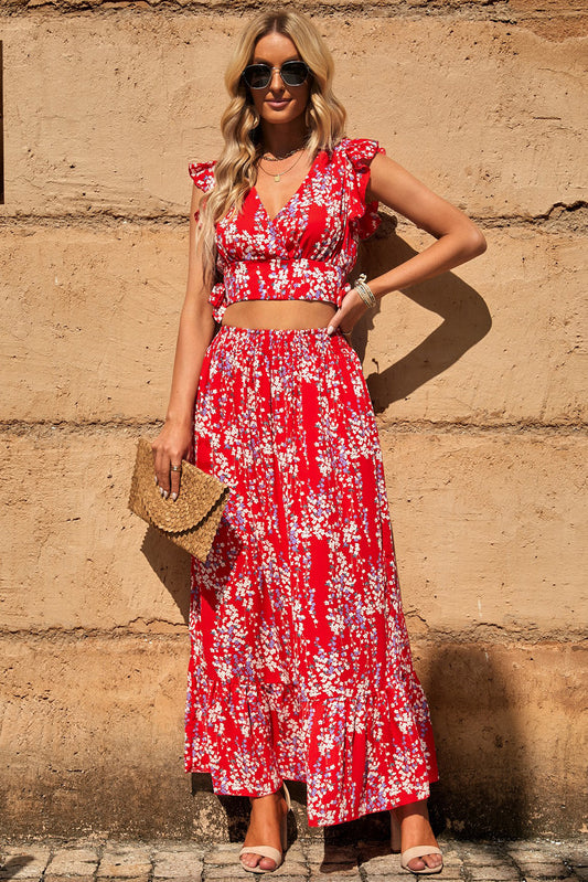 Chic Summer Outfit featuring a Floral Print Tie-Back Cropped Top & Maxi Skirt Set, model posing with stylish accessories against a textured wall.