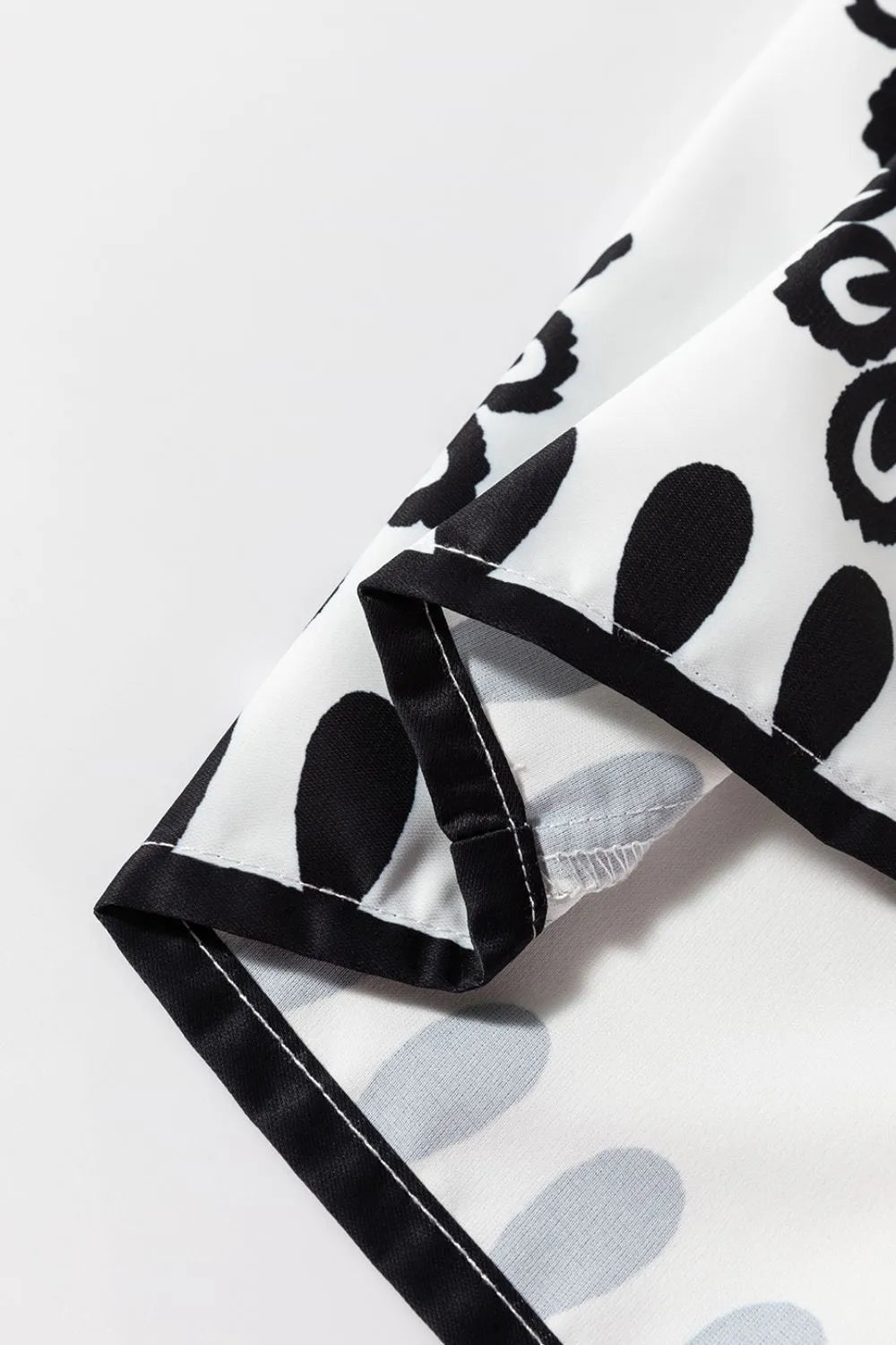 Detailed view of the hem of the Tied Printed Shorts, showcasing the intricate black and white print, perfect for stylish summer outfits.