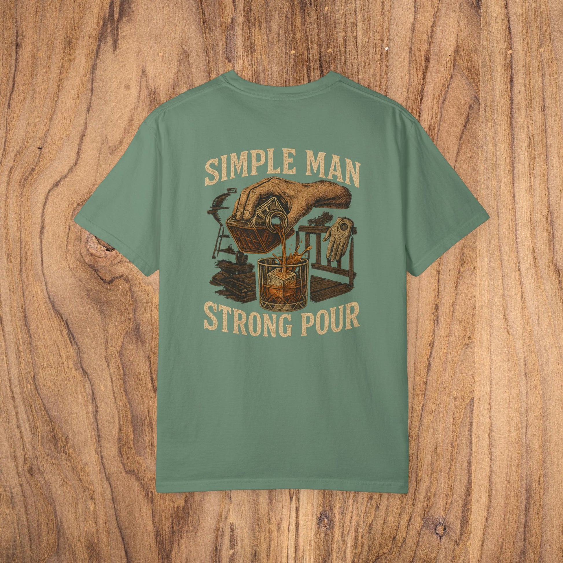 Simple Man Strong Pour T-Shirt in olive green featuring an artistic graphic of a hand pouring into a glass, embodying a stylish and classic fit for everyday wear.