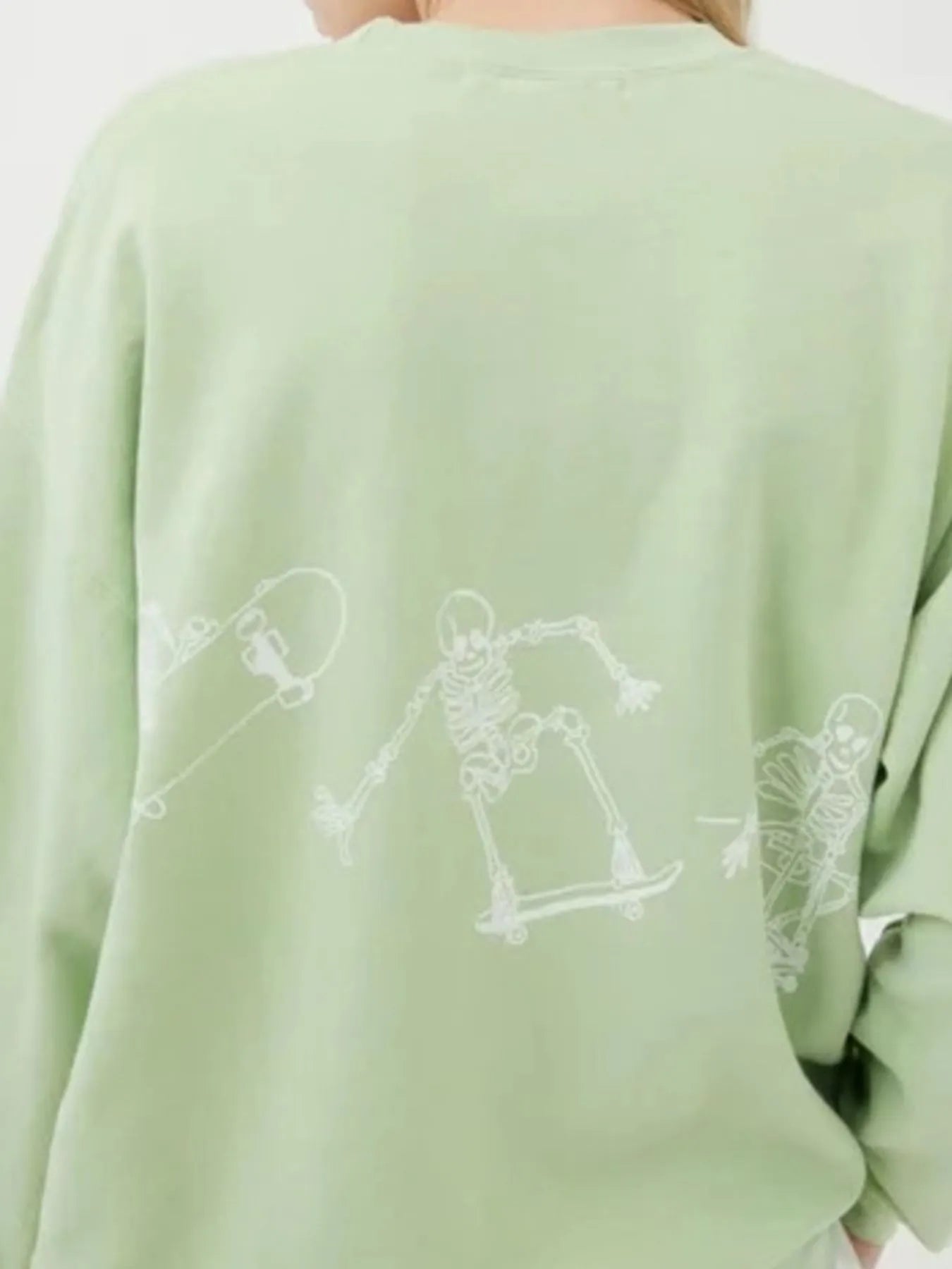 Oversized Skeleton Graphic Sweatshirt for Women featuring a playful skeleton design on the back, perfect for adding a trendy flair to your casual outfit.