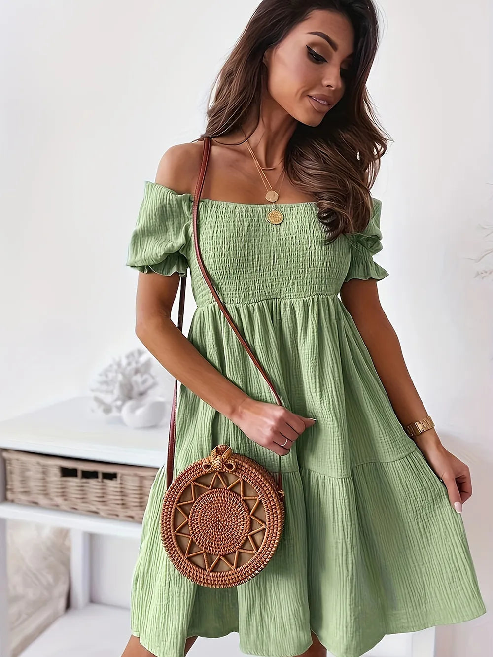 Model wearing a full size ruffled off-shoulder dress with short sleeves in green, showcasing a chic and ruched design.