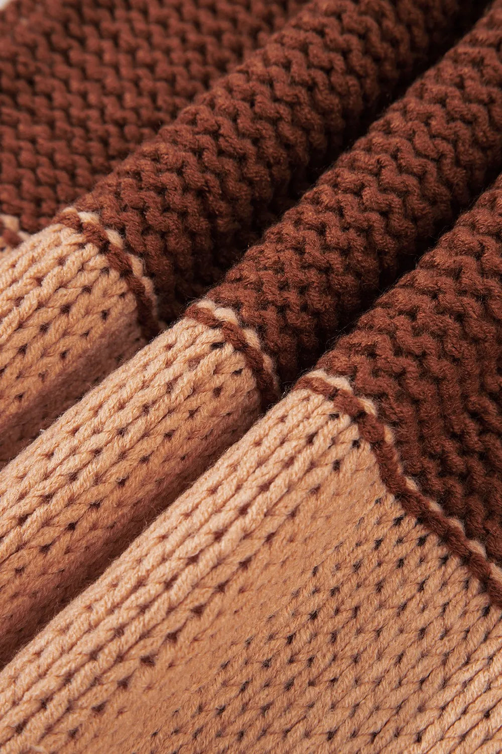 Folded fabric of the Stylish Colorblock Striped Sweater with Round Neck, emphasizing the soft texture and harmonious color blocks. A must-have piece for effortless style and comfort.