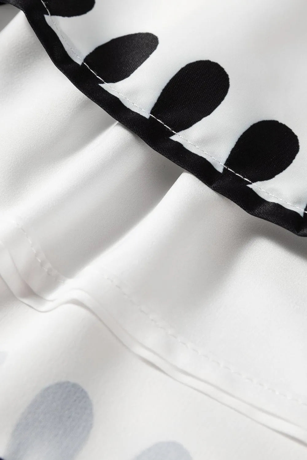 Close-up of Tied Printed Shorts showcasing stylish black and white polka dot fabric detail, perfect for summer fashion.