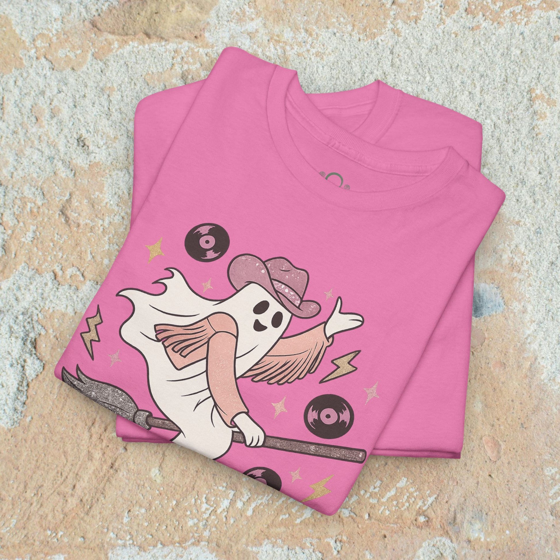 Spooky Cowgirl Graphic Tee featuring a playful ghost character in a pink shirt and cowboy hat, surrounded by vinyl records, highlighting soft fabric and eco-friendly materials.