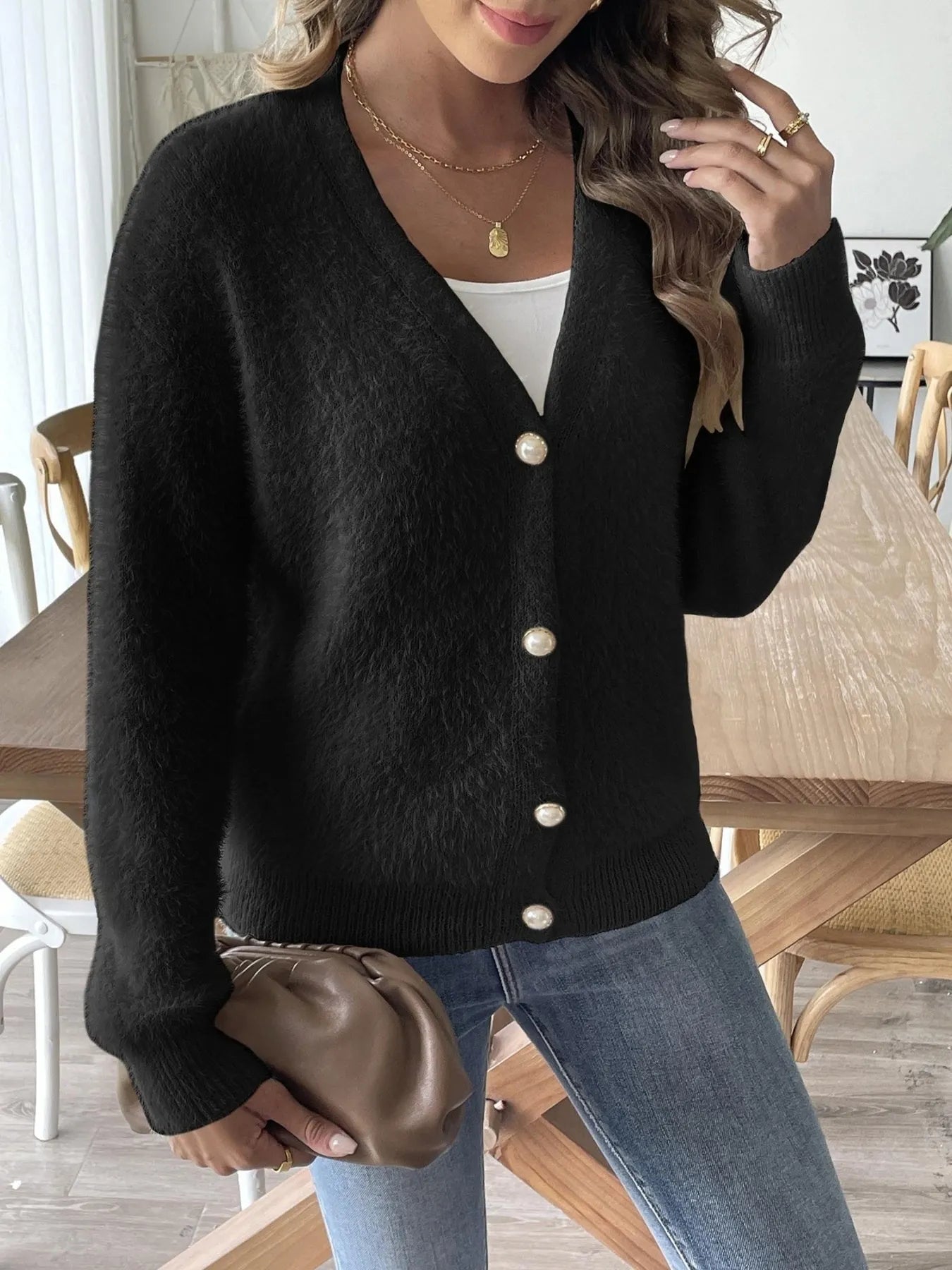 Trendsi Fuzzy Button-Front Cardigan in black, featuring a button front, styled with blue jeans and a brown handbag for an elegant casual look.