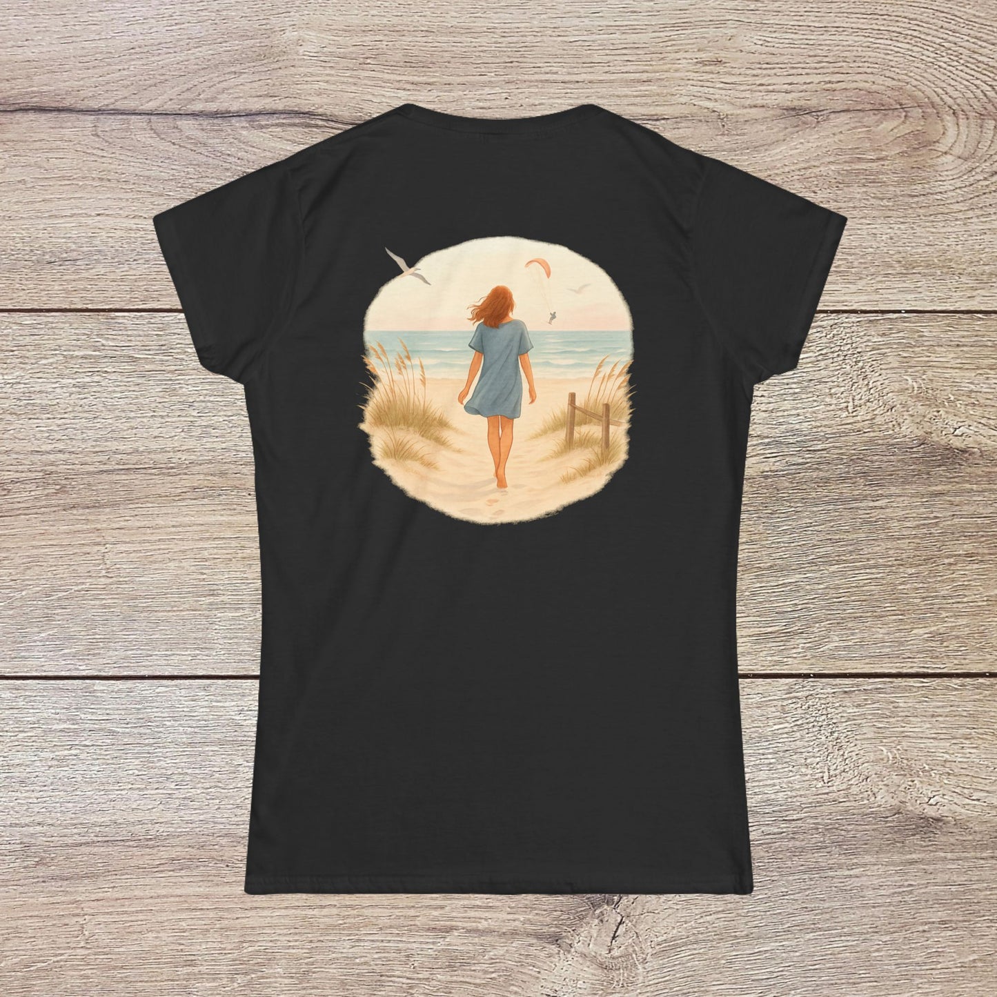 Back view of Women's Coastal Spirit Midweight Cotton Tee in black - Soft, breathable, semi-fitted beachwear adorned with a tranquil ocean scene, ideal for laid-back beach days.