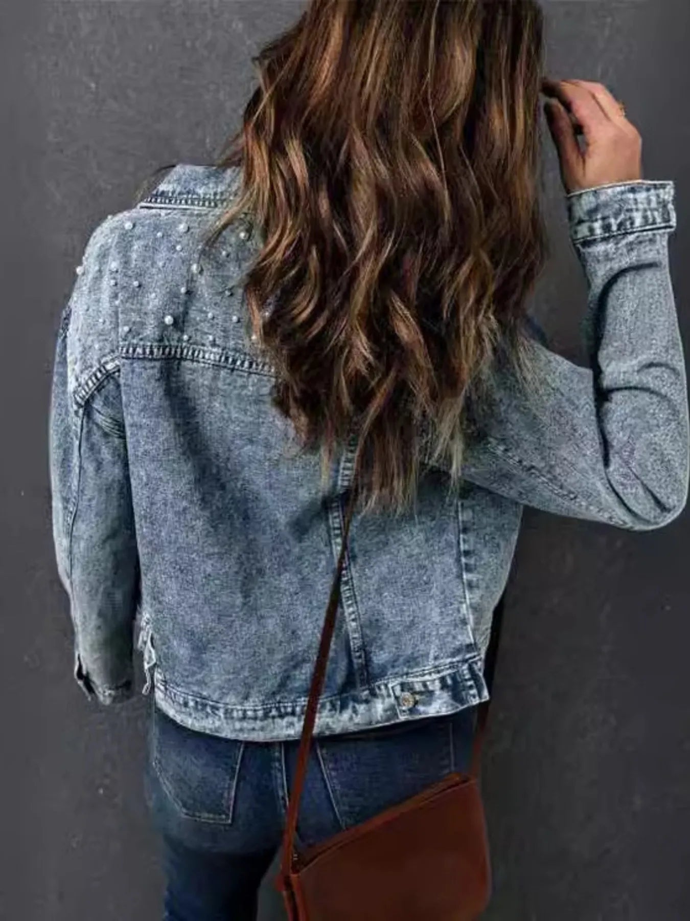 Back view of a Plus Size Denim Jacket with Pearl Detail and Button Up Closure, highlighting the intricate pearl design and relaxed style.