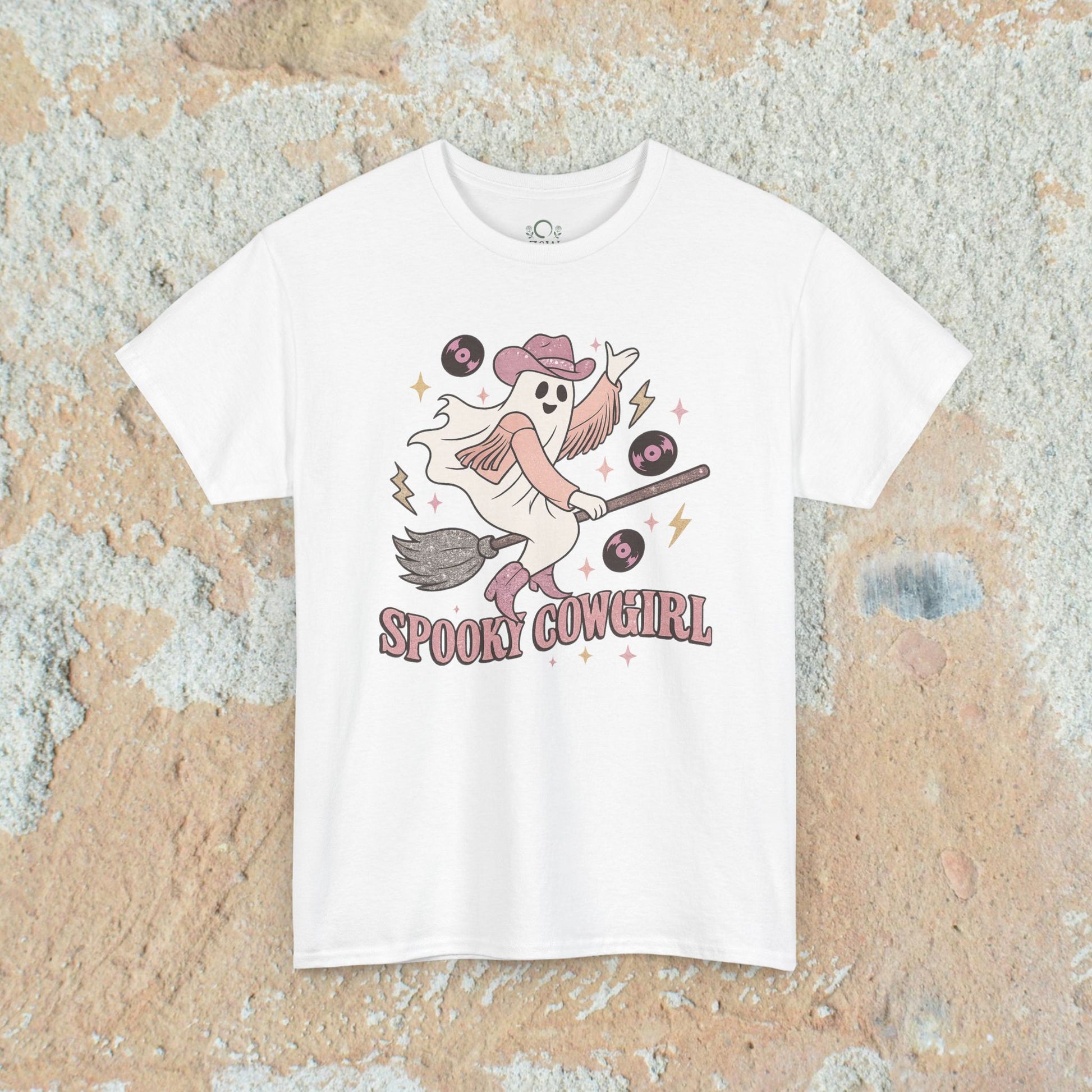 Spooky Cowgirl Graphic Tee featuring a playful ghost with a cowboy hat on a broom, surrounded by vinyl records, perfect for Halloween enthusiasts.
