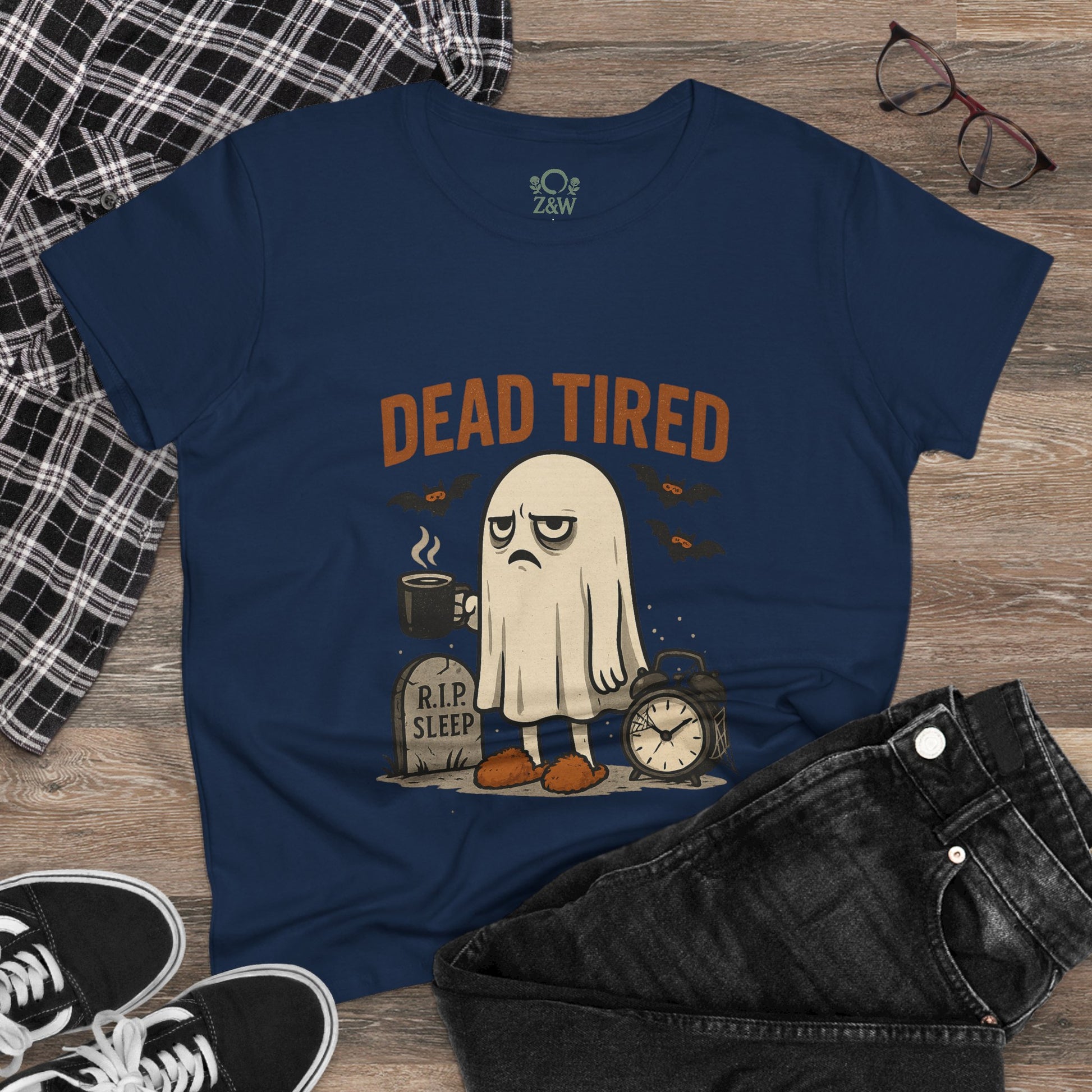Casual Cute Whimsical Ghost T-Shirt for Halloween displaying a tired ghost design alongside coffee and clock images on a navy shirt, perfect for relaxed autumn days.