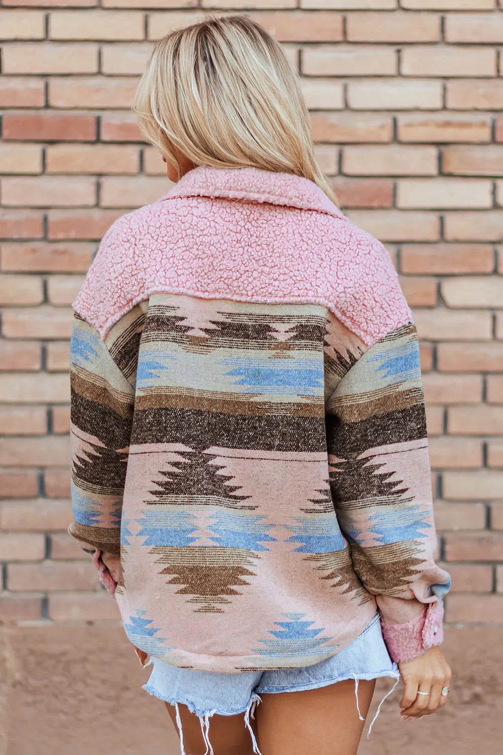 Back view of the Trendsi Button Up Long Sleeve Jacket, emphasizing the colorful patterns against a brick wall backdrop.