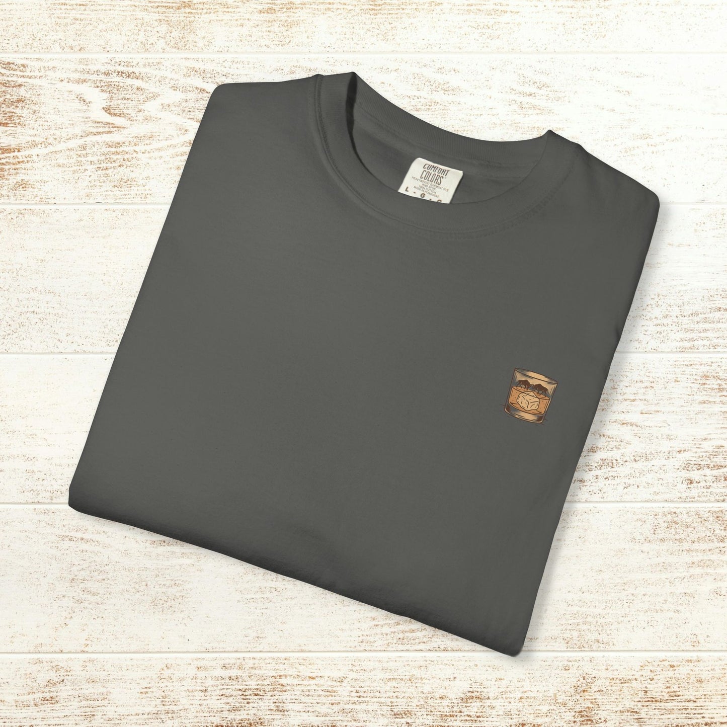 Rodeo On The Rocks Tee shown flat in a dark color, emphasizing the soft 100% US cotton material and its premium quality, suitable for casual wear.