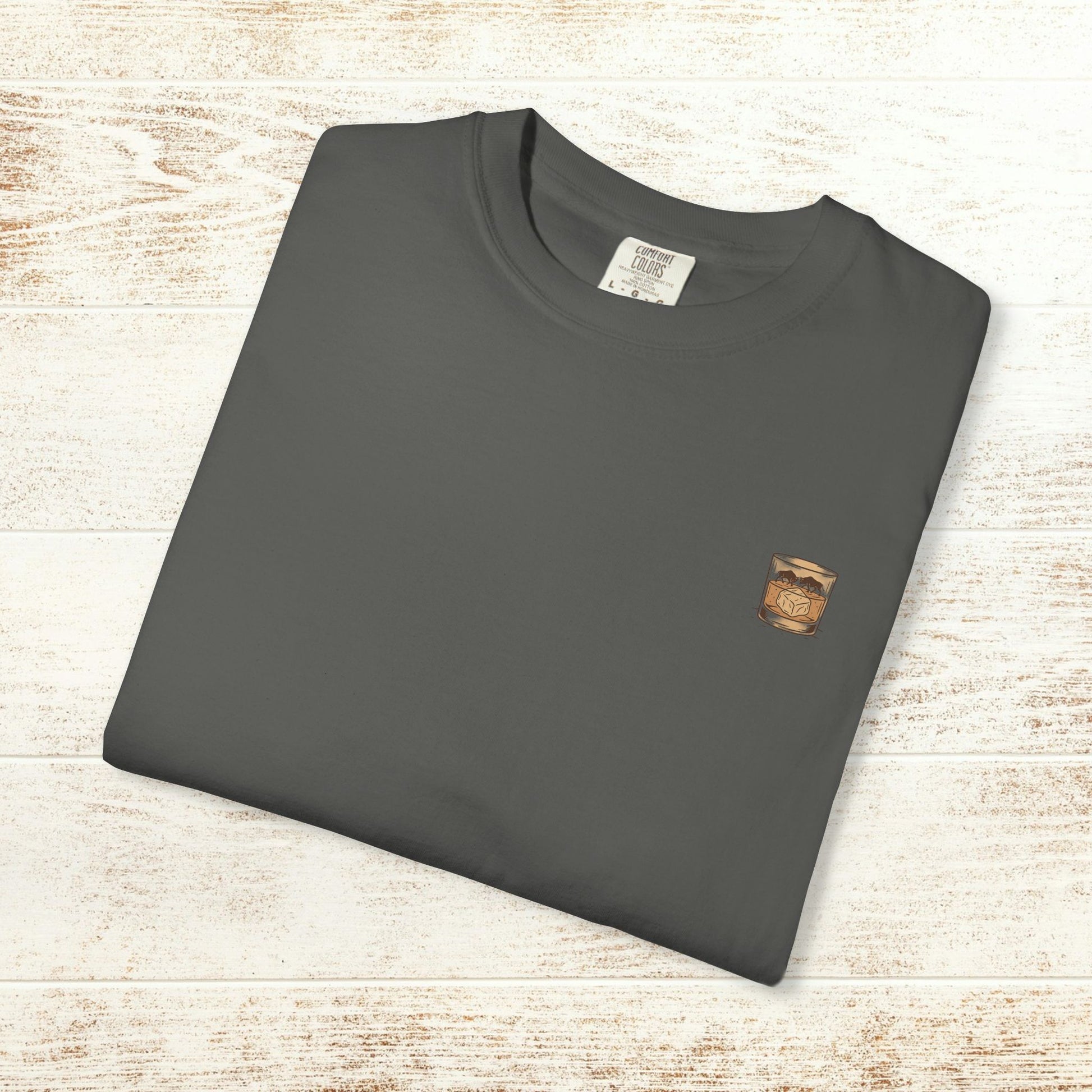 Rodeo On The Rocks Tee shown flat in a dark color, emphasizing the soft 100% US cotton material and its premium quality, suitable for casual wear.