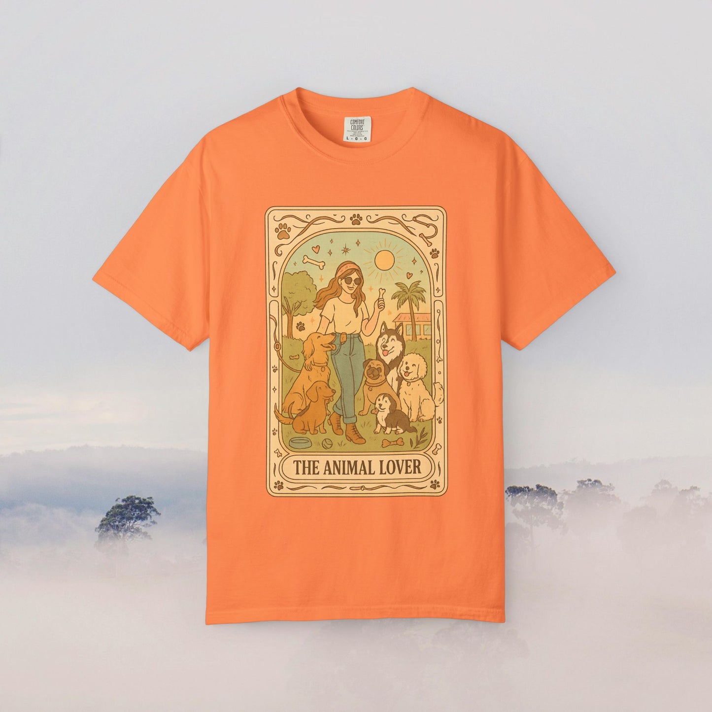 Animal Lover Tarot Tee in vibrant orange color displaying a charming illustration of a woman with several pets, ideal for expressing love for animals.