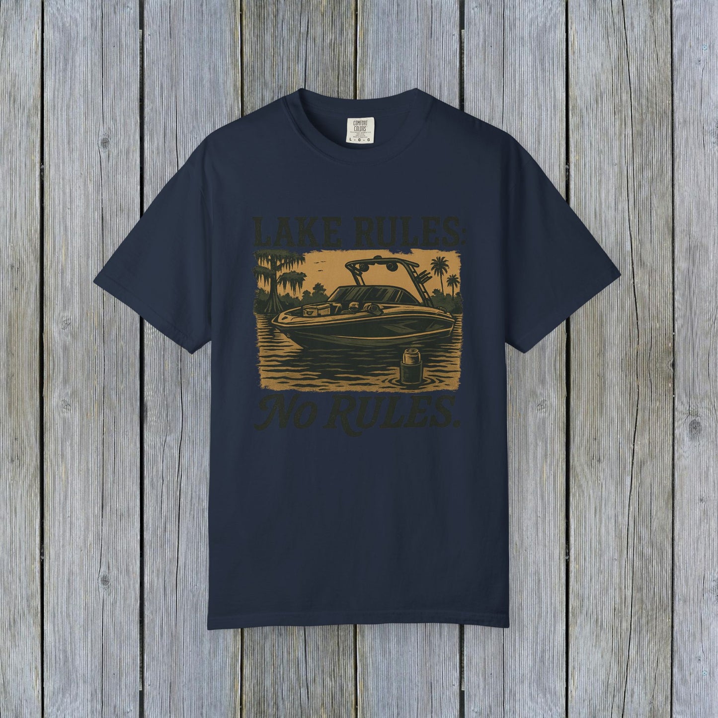 Front view of Unisex Garment-Dyed Lake Rules Tee showcasing a boat graphic and 'Lake Rules: No Rules.' Designed for comfort and outdoor adventures.
