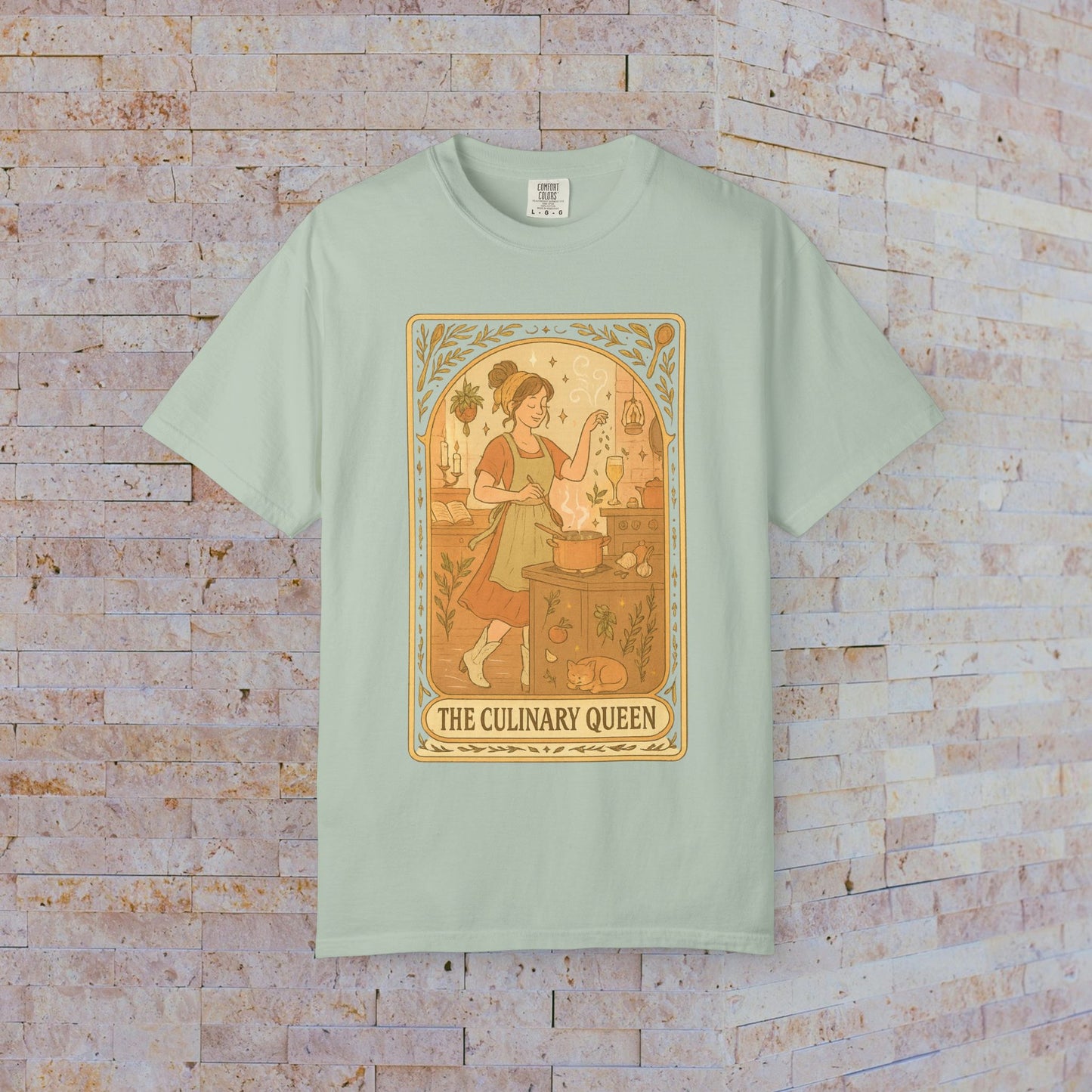 Culinary Queen Tarot Tee in mint green, depicting a delightful artwork of a girl cooking. This soft cotton shirt is available in sizes S to 4XL and comes pre-shrunk.