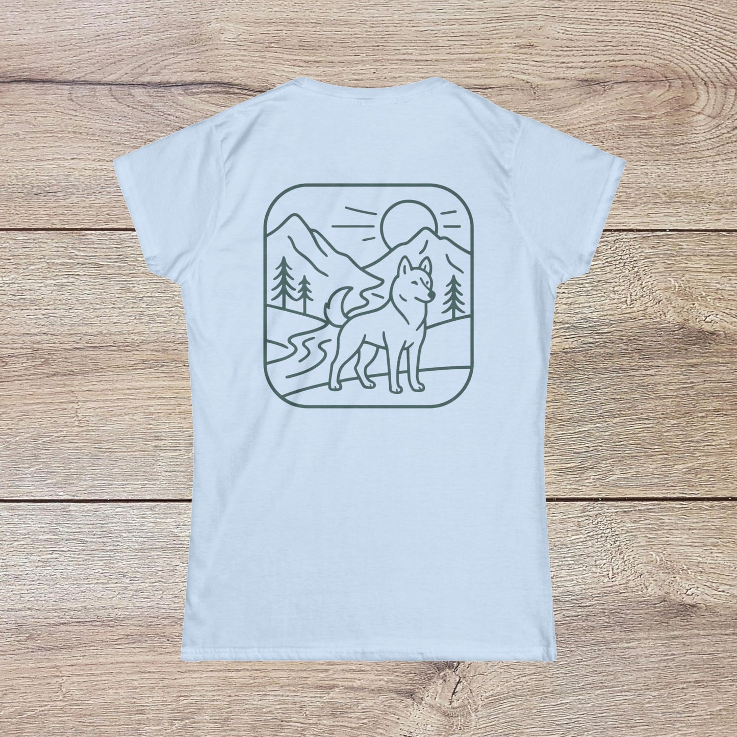 Eco-Friendly Dog T-Shirt - Adventure Spirit displayed in a light blue color with a scenic mountain and dog graphic on the back.