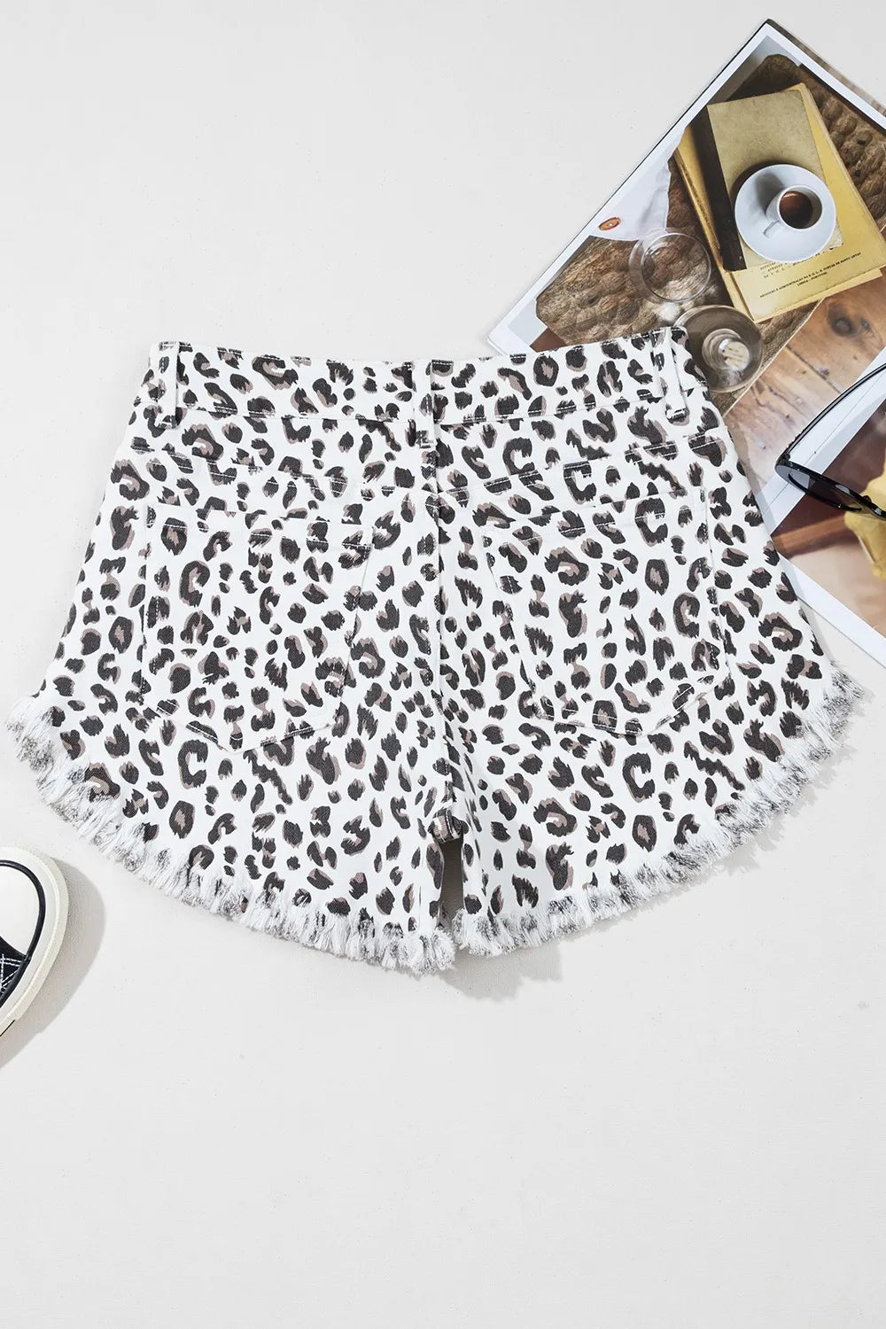Leopard Frayed Hem Denim Shorts - Front view showcasing stylish leopard print design and frayed hem.