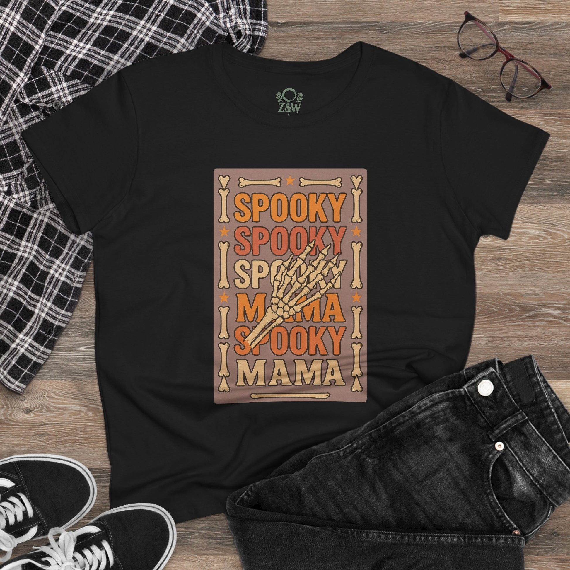 Spooky Mama Tee styled with black jeans, black sneakers, and glasses, exemplifying its versatile and playful style.