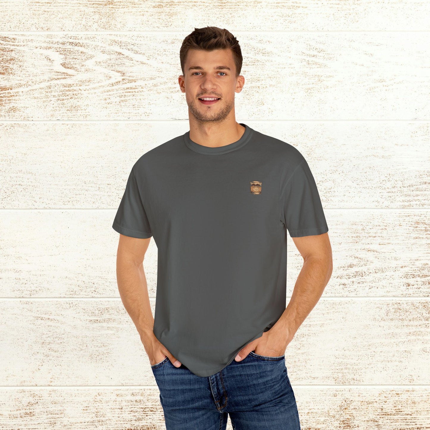 Model showcasing the Rodeo On The Rocks Tee in a dark shade, made of soft 100% US cotton, ideal for a comfortable and fashionable look.