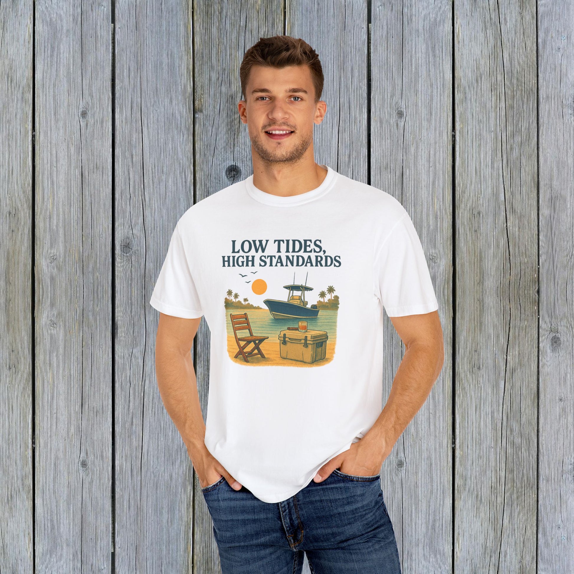 Model wearing a classic white Garment-Dyed Low Tides High Standards T-Shirt, featuring a lively beach illustration, great for casual gatherings.