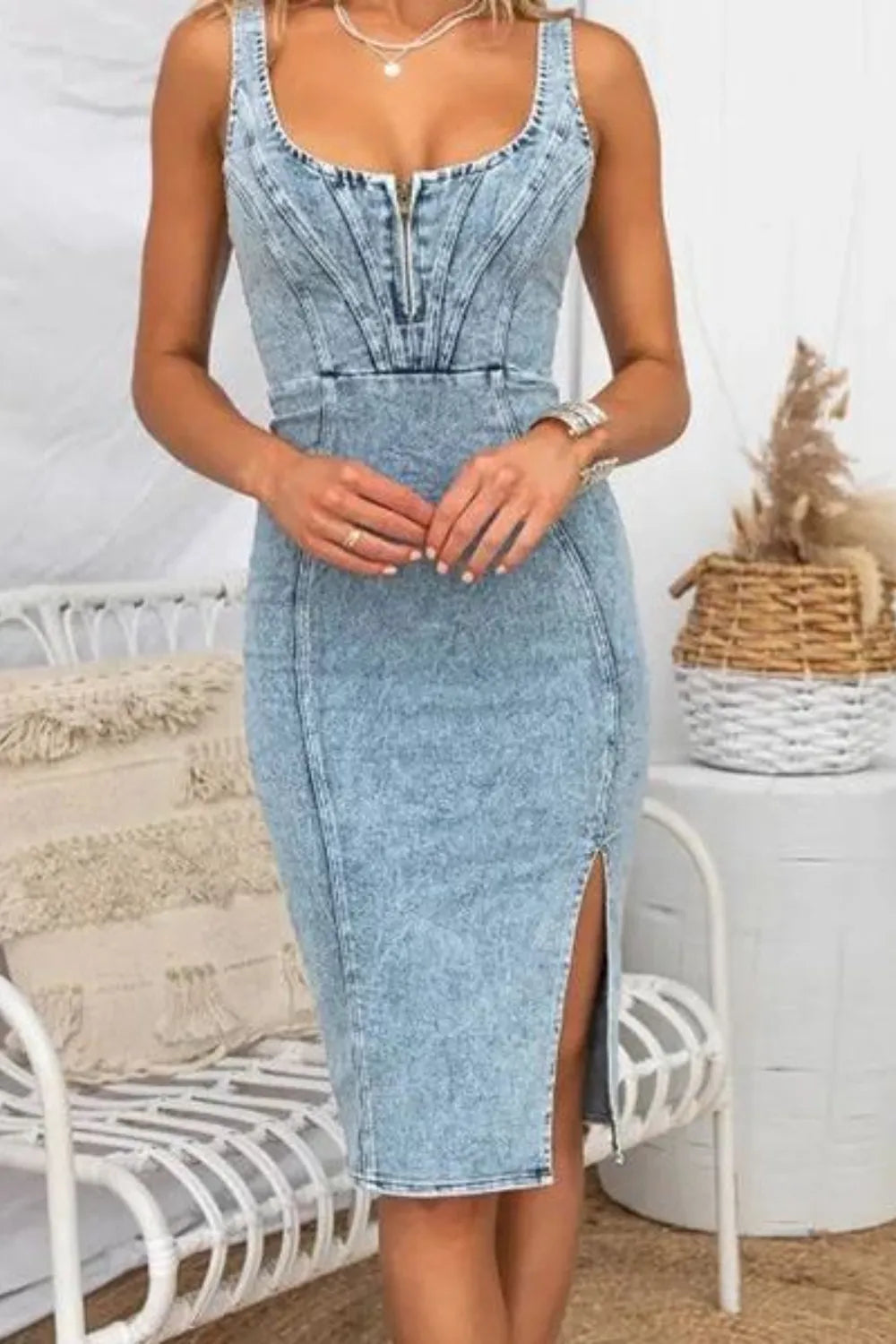 Front view of a denim dress with side slit, washed design and scoop neck, perfect for dressing up or down.