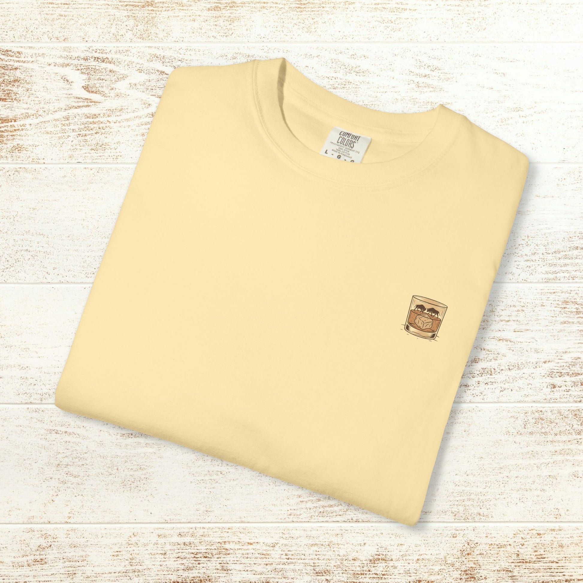 Rodeo On The Rocks Tee folded neatly, showcasing the small logo of a drink glass, made from soft 100% US cotton for durability and comfort.