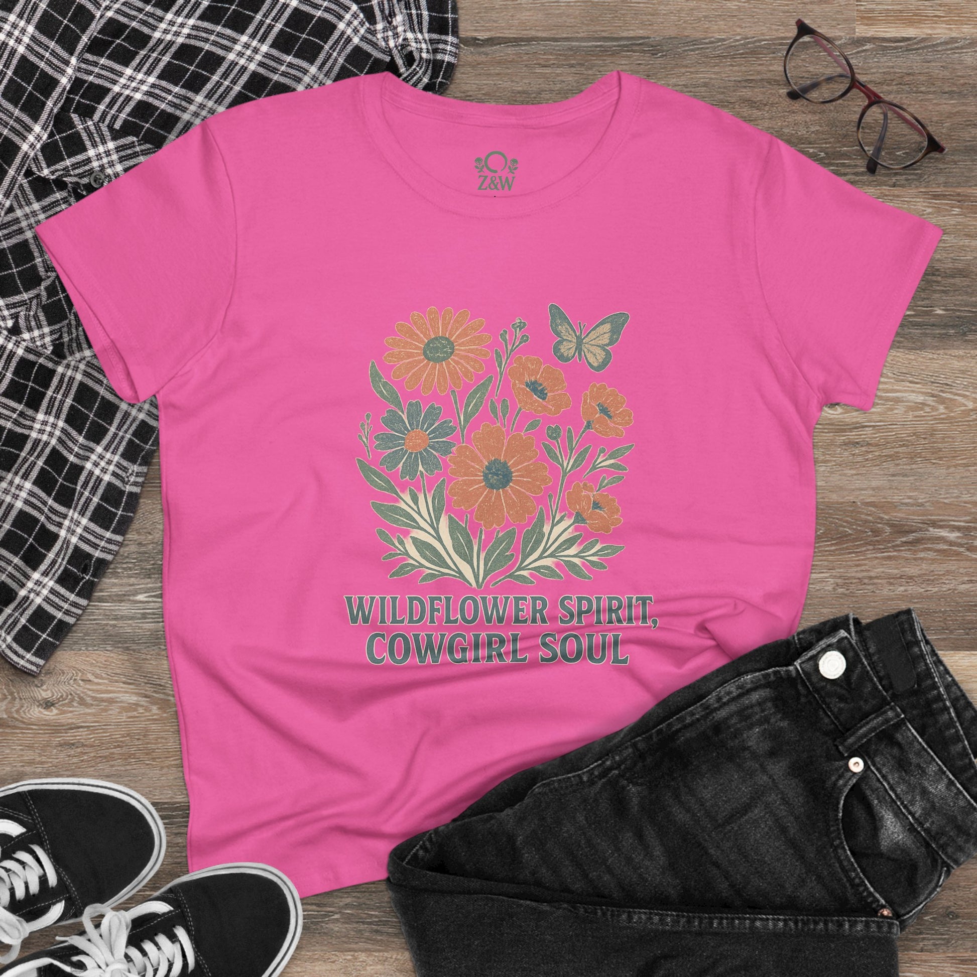 Wildflower Spirit Cotton Tee in lovely light pink, featuring an eye-catching floral print and 'Wildflower Spirit, Cowgirl Soul' text, making it a chic addition to your outfit.