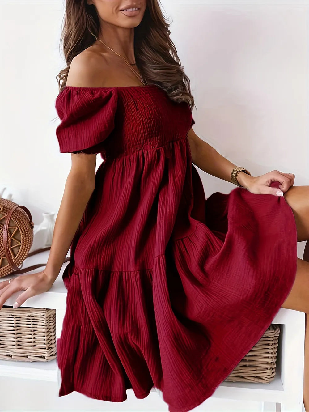 Full Size Ruffled Off-Shoulder Dress with Short Sleeves - Stretchy, Chic & Ruched Design in deep red, showcasing a model sitting elegantly.