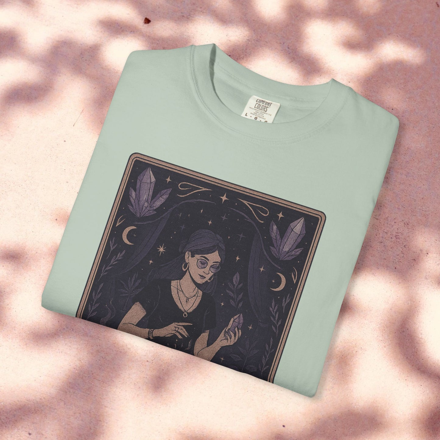 Intuitive Tarot Tee in soft green featuring a unique design with a woman holding a crystal, surrounded by mystical elements, ideal for tarot enthusiasts.