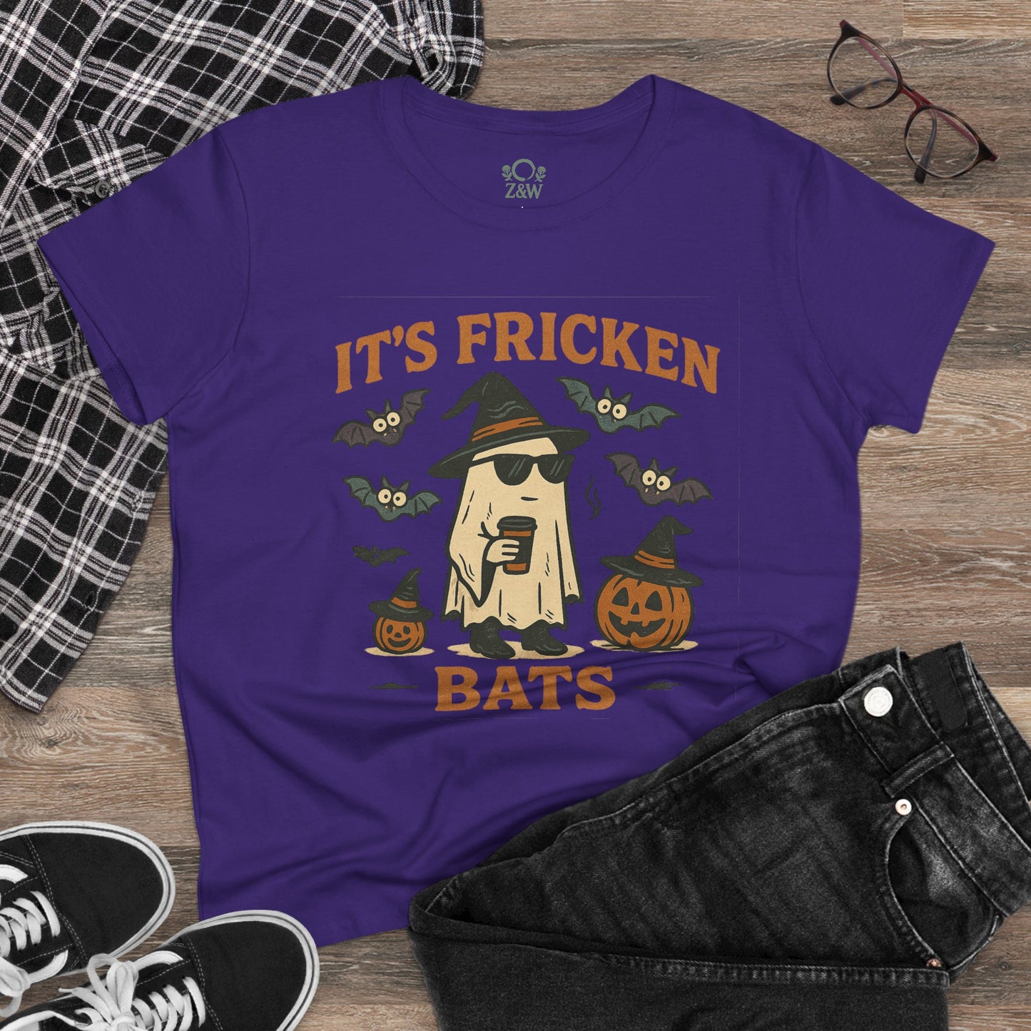 Halloween Unisex T-Shirt featuring a fun graphic of a ghost with sunglasses, bats, and pumpkins in purple. Ideal for Halloween and trick-or-treating.