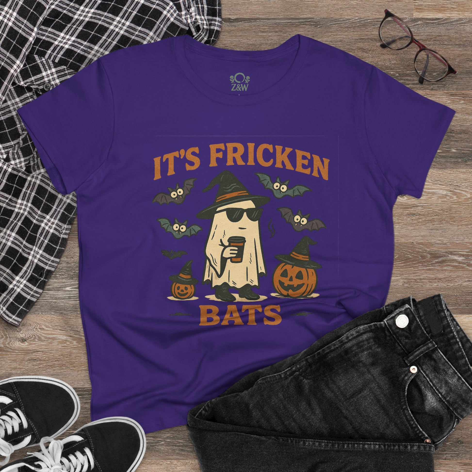 Halloween Unisex T-Shirt featuring a fun graphic of a ghost with sunglasses, bats, and pumpkins in purple. Ideal for Halloween and trick-or-treating.