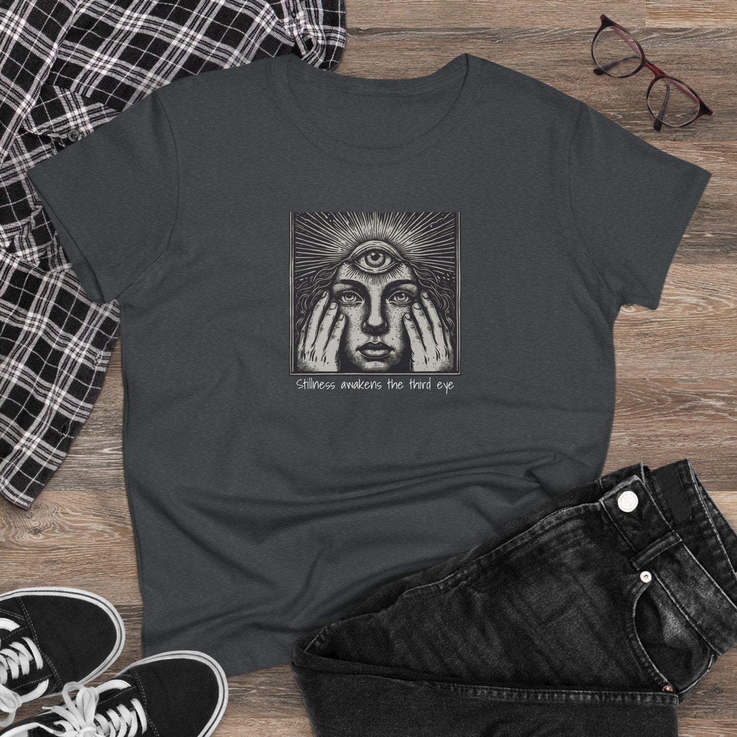 Stylish Third Eye Graphic Tee displayed on wooden background with casual outfit elements, showcasing its unique design and cropped fit.