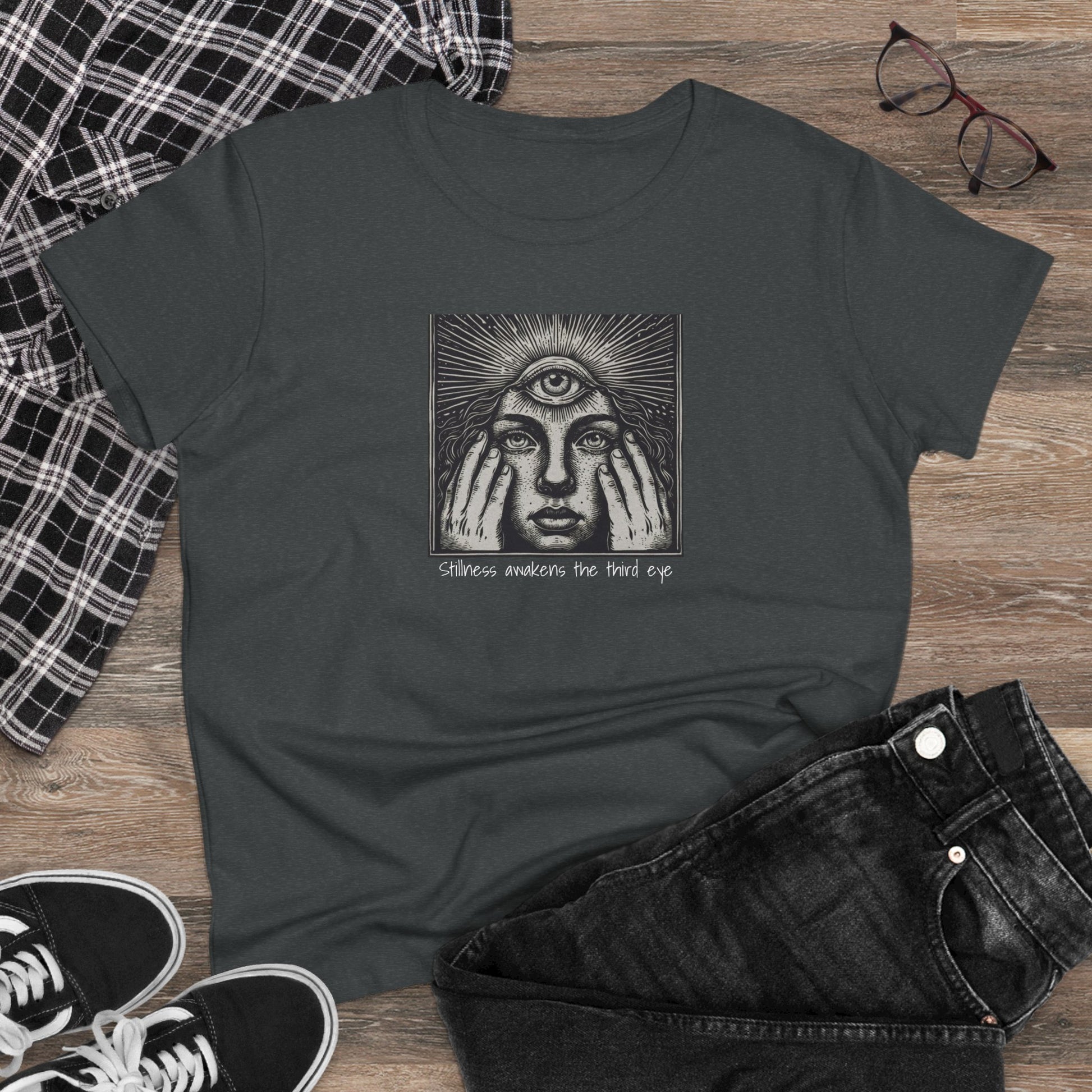 Stylish Third Eye Graphic Tee displayed on wooden background with casual outfit elements, showcasing its unique design and cropped fit.