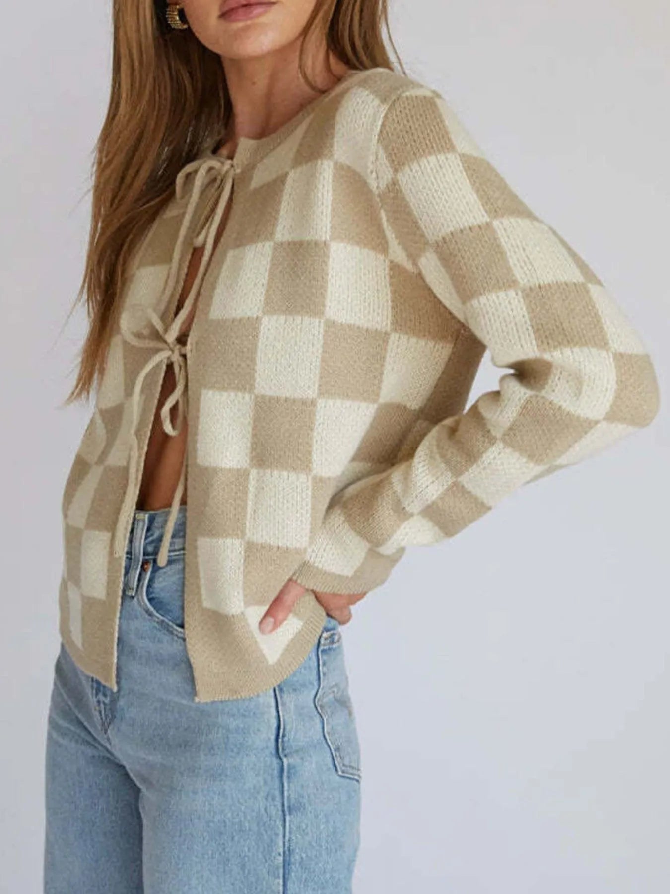 Close-up of the Checkered Tie-Front Cropped Cardigan for Women, showcasing the chic tie-front detail and comfortable fit in a beautiful cream and beige checkered design, crafted from slightly stretchy 100% polyester.
