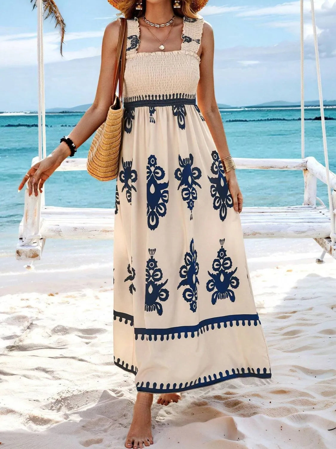 Trendsi Smocked Printed Maxi Dress with Wide Straps - Elegant Opaque, Non-Stretch Design, modelled on a sandy beach, showcasing a stylish navy motif and a breezy, comfortable fit perfect for warm weather.