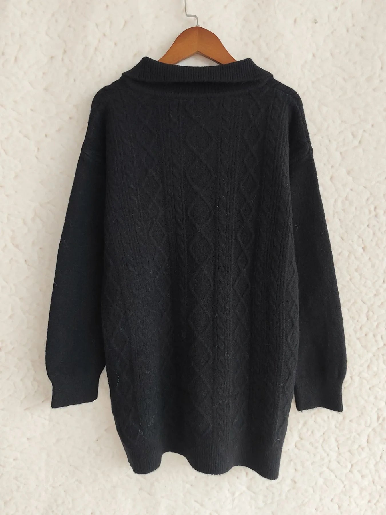 Back view of the Cozy Cable-Knit Texture Zip Collar Long Sleeve Sweater in black, showcasing the intricate cable-knit design.