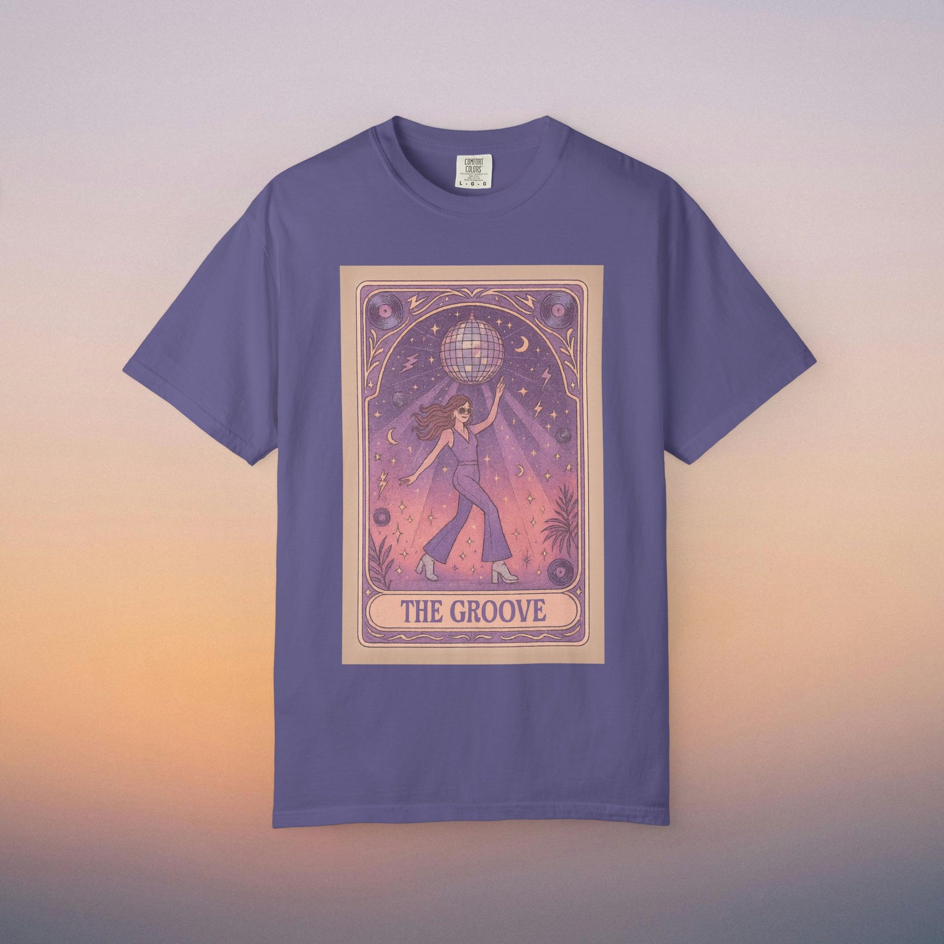 Groove Tarot Graphic Tee in purple, featuring a whimsical design of a figure holding a disco ball, perfect for tarot enthusiasts and stylish casual wear.